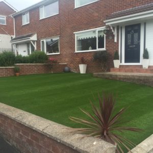 Front lawn laid with artificial turf, striped